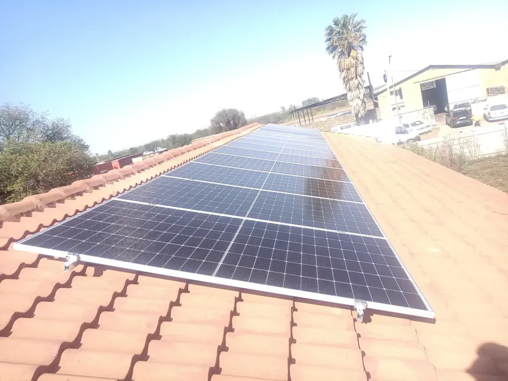 Solar panels on the tiled roof of the EFJS Printing building